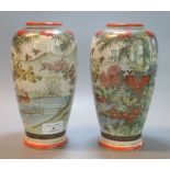 Pair of early 20th century Japanese pottery vases, hand painted with a lake scene surrounded by