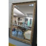 Modern gilt framed, bevel plate mirror, the frame with moulded leaf and berry decoration. 71x104cm