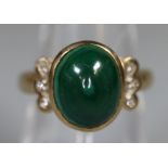 Green cabouchon set gold dress ring with diamond chip shoulders. Unmarked. 5.4g approx size M. (B.P.