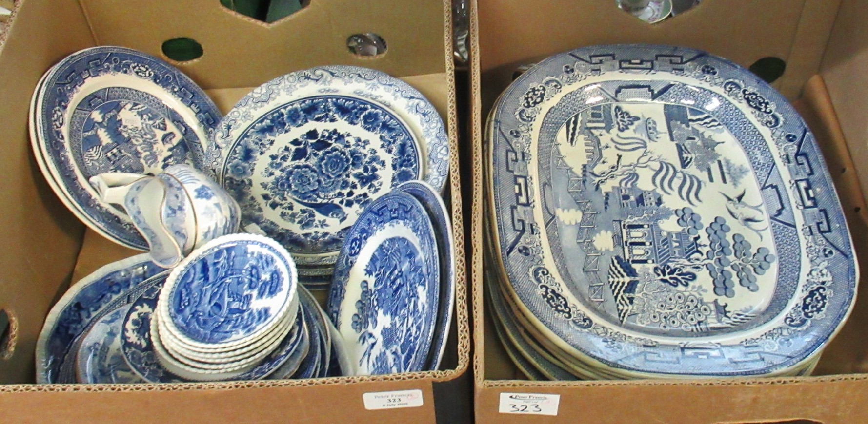 Two boxes of blue and white china to include: Seven large oval Staffordshire 'willow pattern' meat