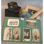 Box with album and tin of various postcards, album of old family photographs, small album of Trex