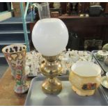 Three items: brass oil lamp with clear glass chimney and white glass shade, together with