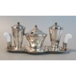 An Art Deco silver plated 3 piece cruet set with white bakelite handles on stand. (B.P. 21% + VAT)