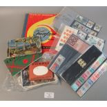 Small box with album of all world stamps, few presentation and collectors packs, various postcards