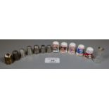 A collection of thimbles including four silver thimbles, five Singer sewing machine thimbles, a