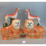 Pair of Staffordshire pottery greyhounds with rabbit prey on green naturalistic bases together