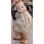 Vintage life-size baby doll with moveable limbs (plastic) in vintage cloths. (B.P. 21% + VAT)