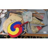 Two trays of oriental fans of various ages and materials: Silk, embossed paper, wooden, palm leaf
