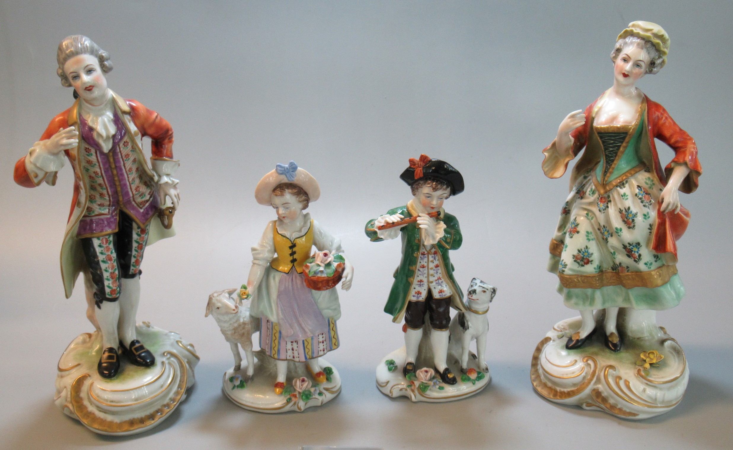 Collection of continental porcelain hand-painted figurines, to include young boy and girl with dog