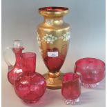 Four items of Victorian cranberry glass to include decanter and stopper, bottle vase, cream jug