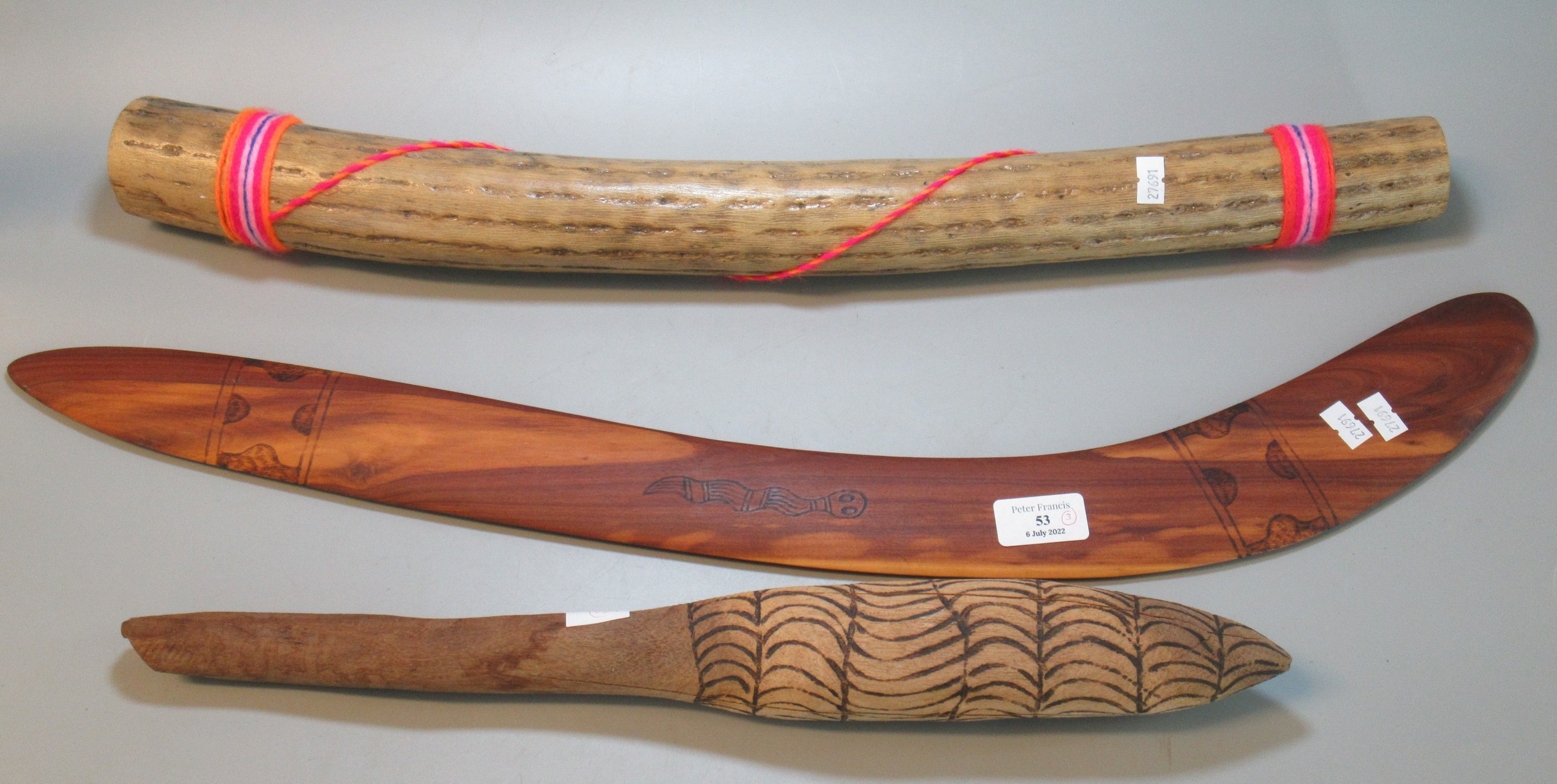 Souvenir Wooden Australian Boomerang together with a Rainmaker and another wooden implement (3) (B.