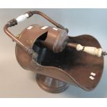 Victorian copper helmet shaped coal scuttle with swing and ceramic handle together with a matching