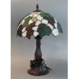 Modern Tiffany style table lamp, the shade overall with leaf and berry decoration. (B.P. 21% + VAT)