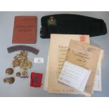 An Intelligence Corps cap with a small selection of cap badges etc. (B.P. 21% + VAT)