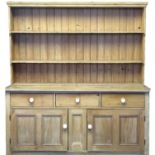 Late 19th century pine four door wardrobe, the moulded cornice above four lattice panels having