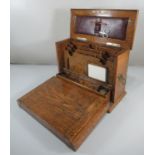 Edwardian oak 'The Gem' stationary box, of plain rectangular form having brass carrying handles, the