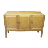 In the style of Brynmawr, an oak sideboard having raised back panel above three blind panel