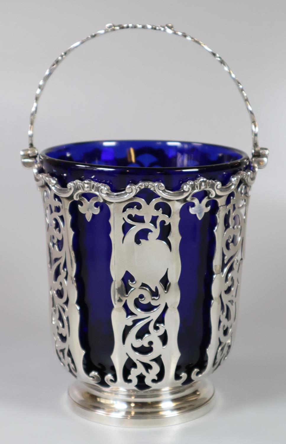 Victorian silver and pierced basket with swing handle and Bristol Blue glass liner by George John