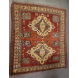 20th century Middle Eastern design carpet on a salmon ground with two central medallions having