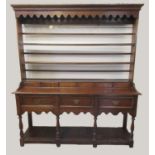 19th century oak two stage open back pot board dresser, the moulded cornice above a shaped apron