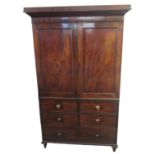 19th century mahogany press cupboard/wardrobe, the moulded cornice above two blind panelled doors,