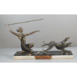 Art Deco design spelter figure group of a kneeling lady with spear and two running hounds, raised on