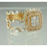 A diamond cluster ring of baguette and brilliant cut stones set in a rectangular setting