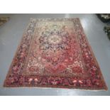 Modern Iranian carpet overall on a salmon ground with central medallion and geometric floral and