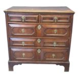 Jacobean style oak straight front chest of two short and three long drawers on a projecting base and