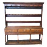 Early 19th century oak open back pot board dresser, the moulded cornice above two fitted shelves