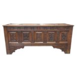 18th century oak coffer, the associate fielded and moulded top above a carved frieze of flower heads