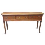 18th century dresser base, the associate moulded top above three fitted drawers with brass