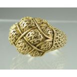 A yellow metal ring heavily engraved and shaped with basketwork shoulders. Ring size P. Engraved