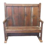 19th century Welsh elm and pine settle, the high boarded back above shaped open arms, moulded seat
