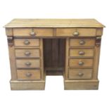 Early 20th century oak knee hole desk, the moulded top above two cock beaded drawers having brass