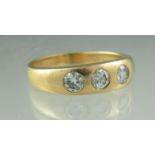 Three stone diamond ring. The three brilliant cut diamonds flush set in 18ct gold. Ring size R.