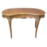 French design walnut kidney shaped desk or table, the moulded and shaped top above a carved design
