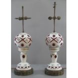 Pair of late 19th century Bohemian overlay cranberry glass table lamps, hand-painted with enameled