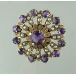 A Victorian circle brooch set with amethyst and seed pearls. Diameter approx 27mm. Approx weight 5.8