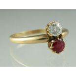 A two stone diamond and ruby ring on 18ct gold band. Ring size P. Approx weight 2.7 grams. (B.P. 21%