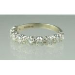 A diamond half eternity ring set in 18ct white gold. Ring size M. Approx weight 2.6 grams. (B.P. 21%