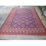 Large Middle Eastern design hand woven carpet on a blue and red ground with central geometric