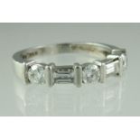 A diamond half eternity style ring set with three brilliant cut and two baguette cut diamonds.