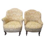 Two similar late Victorian upholstered tub bedroom chairs, both standing on walnut vase shaped front