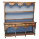 19th century oak two stage, open back pot board dresser, the moulded cornice above shaped apron with