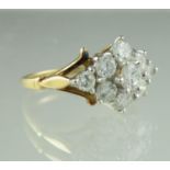 A diamond cluster ring of nine brilliant cut diamonds on an 18ct gold band. Ring size H. Approx