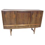 1960's probably Danish rosewood sideboard, having three blind panelled sliding doors above three