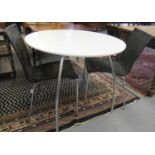 Mid 20th century white melamine circular table on chrome legs together with a pair of black caned