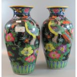 Pair of Japanese polychrome painted baluster vases depicting exotic birds amongst foliage. 31cm high