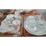 Two Limoges French porcelain teasets on trays; one marked 'Limoges, France, Charles Ahrenfeldt' with